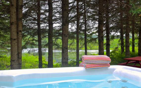 Private jacuzzi chalet to rent front off river available year round fully equipped